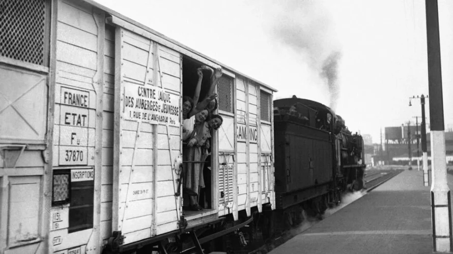女性は、フランスでの有給休暇の導入の3年前の1933年8月にユースホステルに改装された列車のワゴンから手を振って、何十万人もの人々が旅行に拍車をかけるのを助けました。© AFP