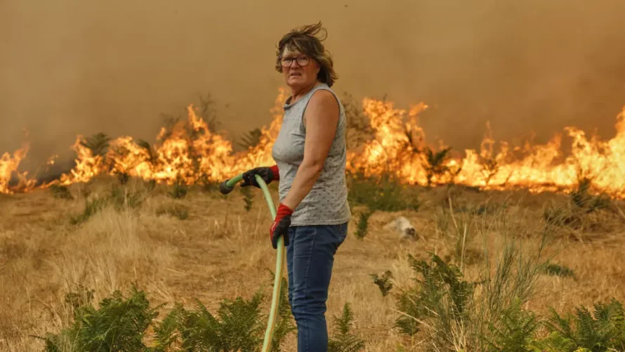 2025年8月14日、スペイン北西部のサンタバイア・デ・モンテスで、女性が山火事の消火を試みている。AP - ラロ・R.ヴィラール